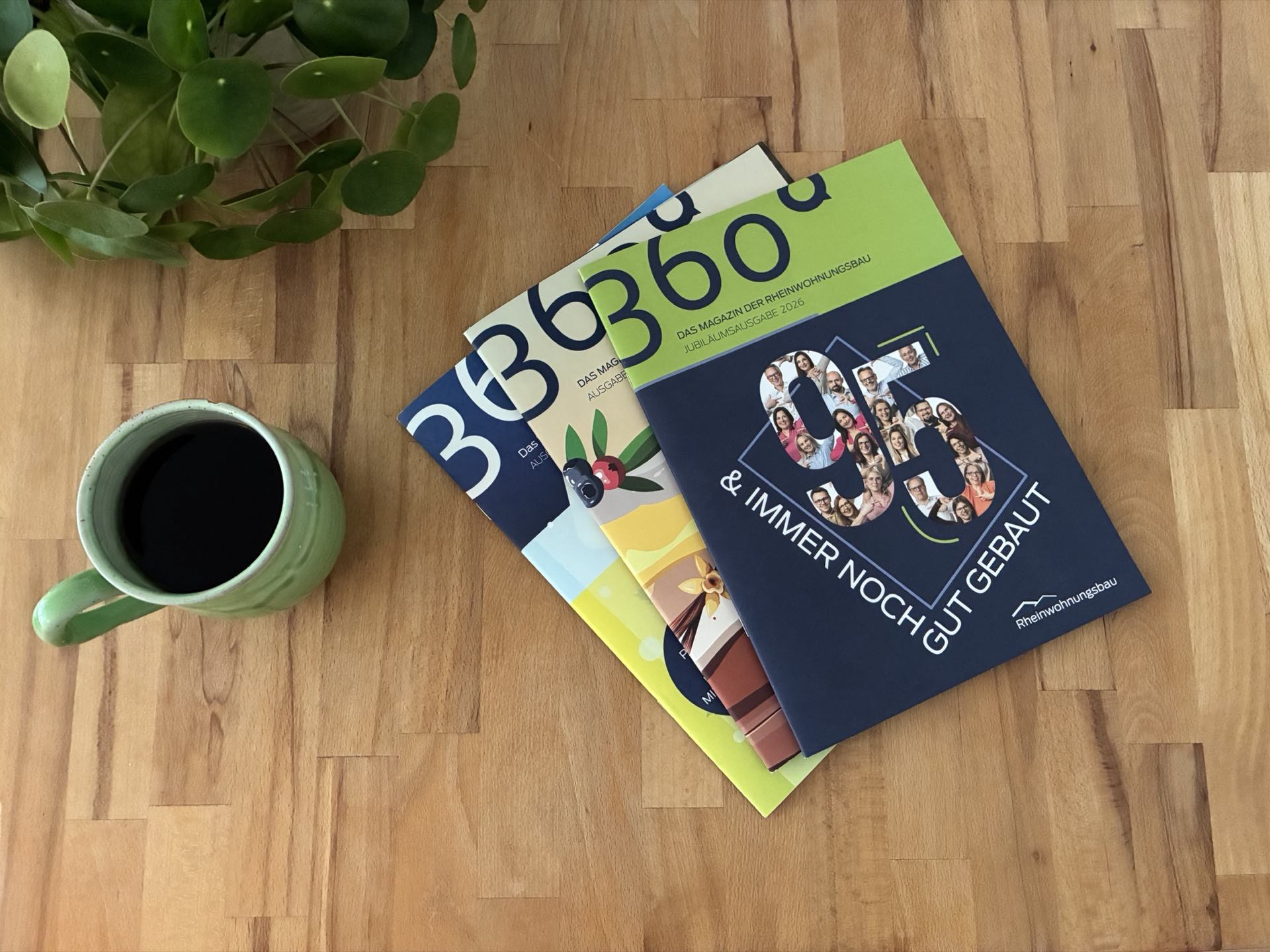 Mehrere Ausgaben des Mietermagazins 360 Grad auf einem Holztisch